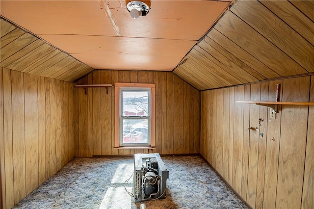 bonus room featuring light carpet, lofted ceiling, and wood walls