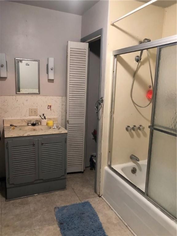 bathroom with vanity and enclosed tub / shower combo