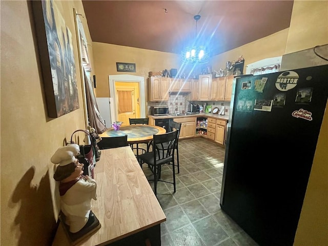 720 Prairie Ave, Mattoon, IL 61938 - kitchen featuring freestanding refrigerator, light brown cabinets, light countertops, stainless steel microwave, and decorative backsplash
