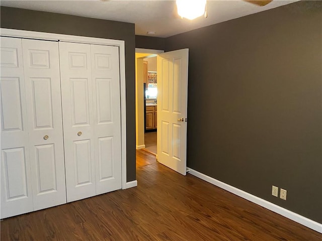 102 10th St, Charleston, IL 61920 - unfurnished bedroom featuring dark wood finished floors and a closet