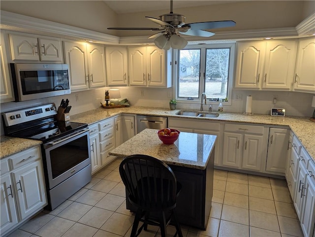 kitchen featuring decorative backsplash, light tile patterned flooring, white cabinets, stainless steel appliances, and a sink