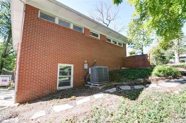 view of side of home with central AC unit