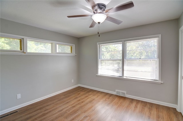 empty room with light wood-type flooring and ceiling fan