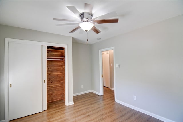 unfurnished bedroom with a closet, light hardwood / wood-style floors, and ceiling fan