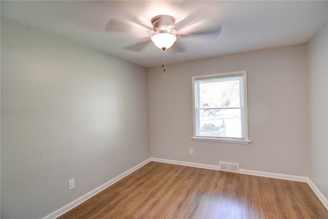 spare room featuring ceiling fan and light wood-type flooring