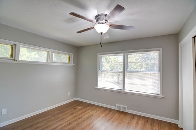 empty room with light hardwood / wood-style floors and ceiling fan