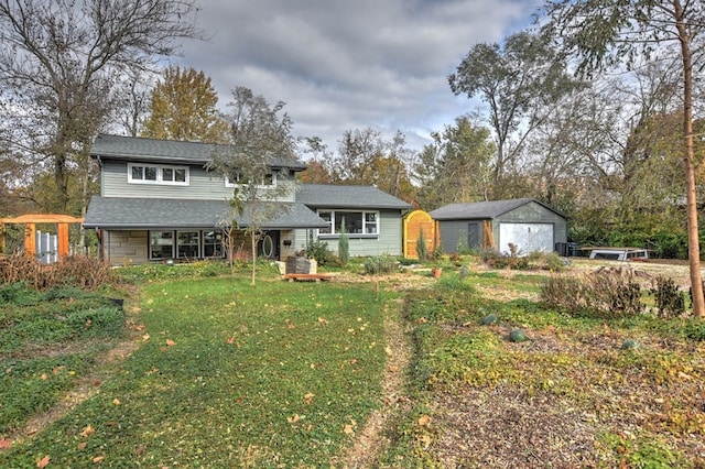 view of front of home with an outbuilding, a front lawn, and a garage