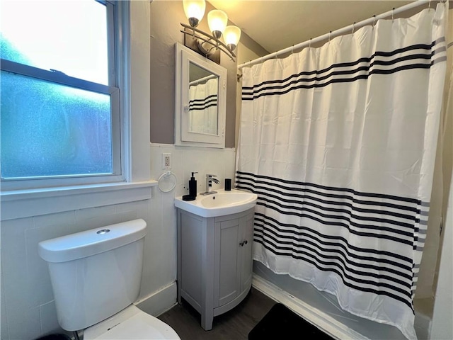 437 Powers Ln, Decatur, IL 62522 - bathroom featuring vanity, healthy amount of natural light, shower / bath combo with shower curtain, and wood finished floors