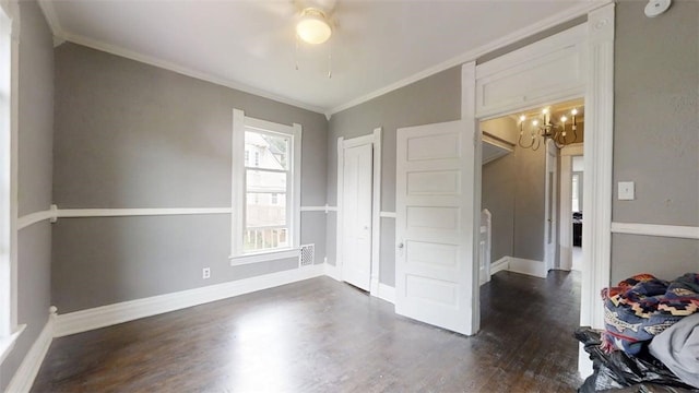 437 Powers Ln, Decatur, IL 62522 - unfurnished bedroom with dark wood-style flooring, crown molding, a chandelier, and ceiling fan