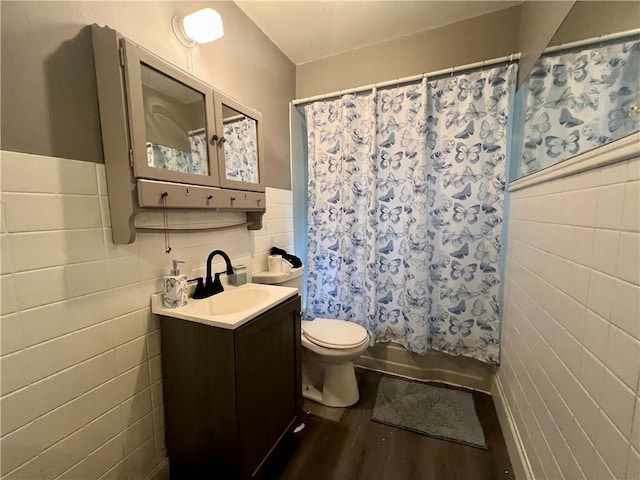 437 Powers Ln, Decatur, IL 62522 - full bathroom featuring tile walls, vanity, shower / tub combo, wood finished floors, and a wainscoted wall