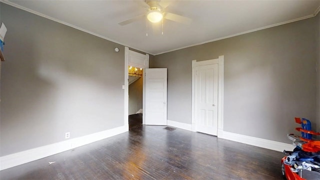 437 Powers Ln, Decatur, IL 62522 - unfurnished bedroom with dark wood finished floors, crown molding, and ceiling fan