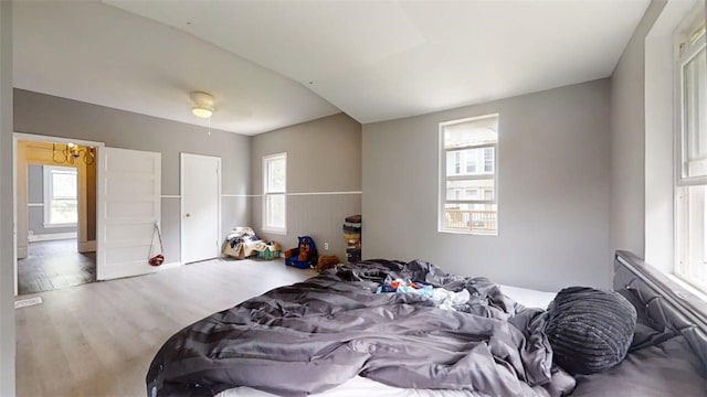 437 Powers Ln, Decatur, IL 62522 - bedroom featuring multiple windows and wood finished floors