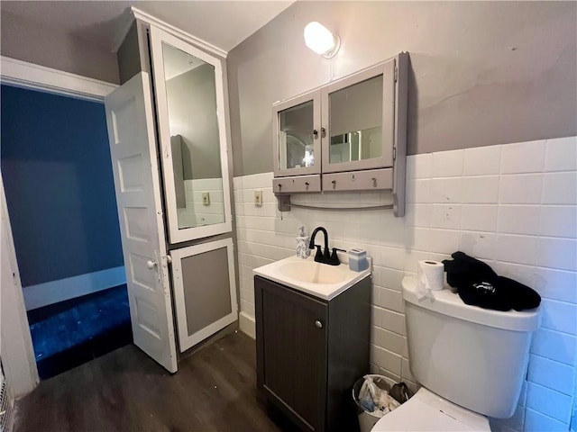 437 Powers Ln, Decatur, IL 62522 - bathroom with wood finished floors, vanity, and tile walls