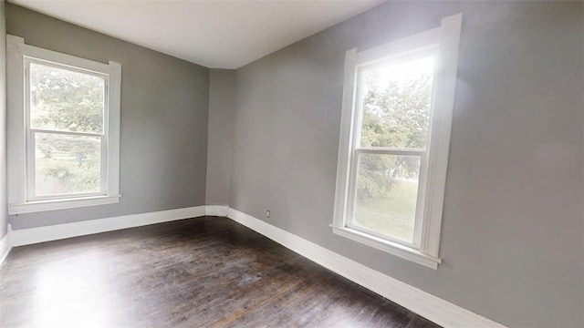 437 Powers Ln, Decatur, IL 62522 - unfurnished room with plenty of natural light and dark wood-type flooring