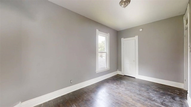 437 Powers Ln, Decatur, IL 62522 - unfurnished room with dark wood-style flooring and baseboards