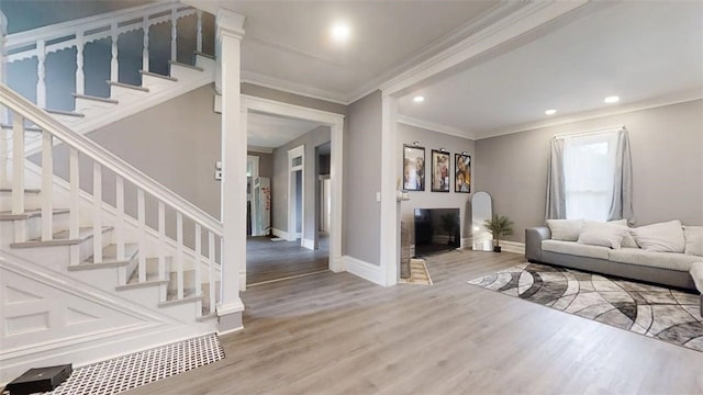 437 Powers Ln, Decatur, IL 62522 - living room with wood finished floors, stairway, crown molding, and recessed lighting