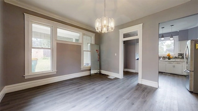 437 Powers Ln, Decatur, IL 62522 - unfurnished dining area featuring a chandelier, wood finished floors, and crown molding