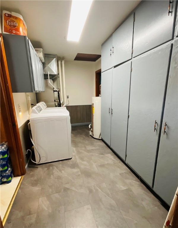 laundry area featuring cabinets, washing machine and dryer, and gas water heater