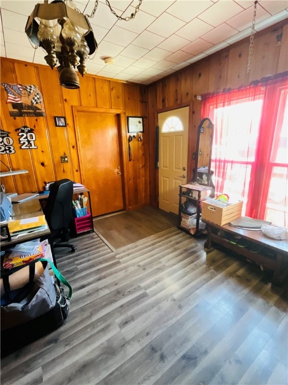 office area with hardwood / wood-style flooring and wood walls