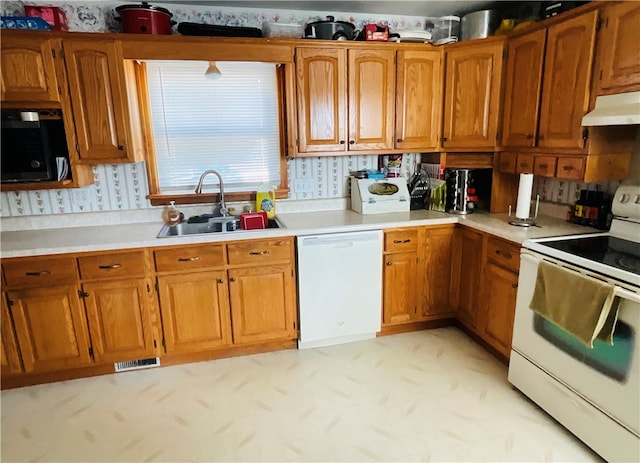 kitchen featuring white appliances and sink