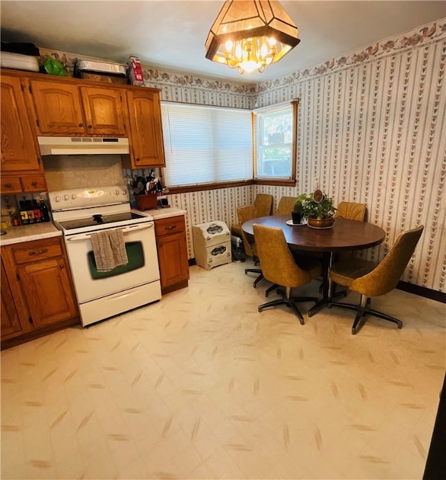 kitchen with electric range and an inviting chandelier