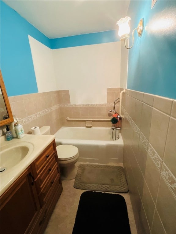 bathroom featuring vanity, a bath, toilet, and tile walls