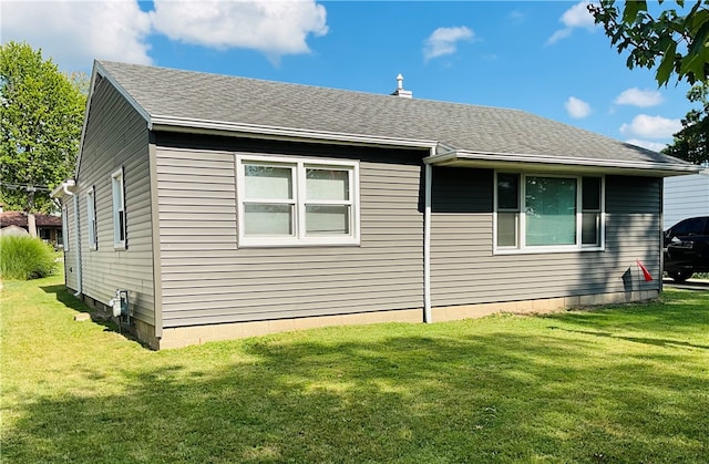 view of property exterior featuring a lawn