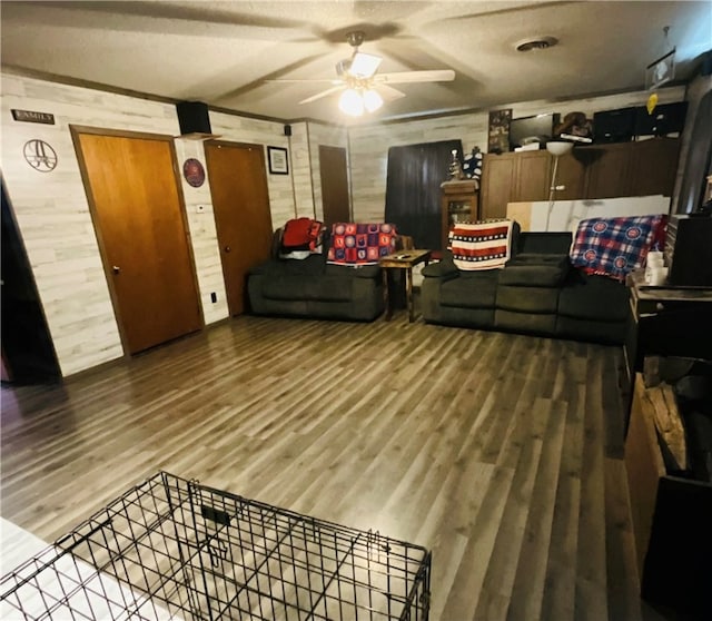 living room featuring hardwood / wood-style flooring and ceiling fan