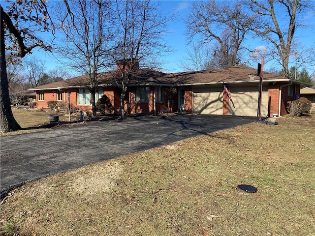 ranch-style home with a garage and a front yard
