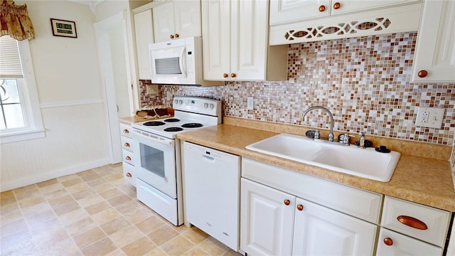 kitchen featuring backsplash, a sink, white appliances, and light countertops