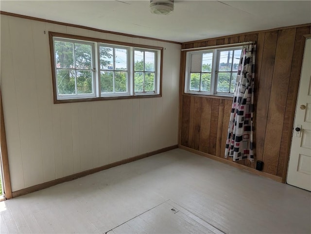 716 N Hazel St, Danville, IL 61832 - spare room featuring baseboards and wood walls