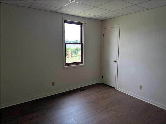 716 N Hazel St, Danville, IL 61832 - unfurnished room featuring a drop ceiling and dark wood-style floors