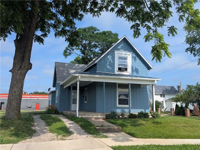 716 N Hazel St, Danville, IL 61832 - bungalow-style house featuring covered porch, a front yard, a standing seam roof, a metal roof, and board and batten siding