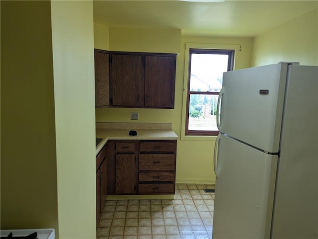 716 N Hazel St, Danville, IL 61832 - kitchen featuring freestanding refrigerator, light countertops, light flooring, and dark brown cabinets
