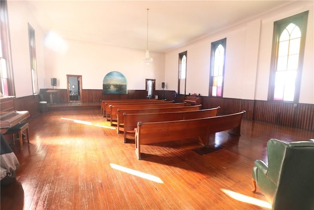 miscellaneous room with hardwood / wood-style flooring and wooden walls