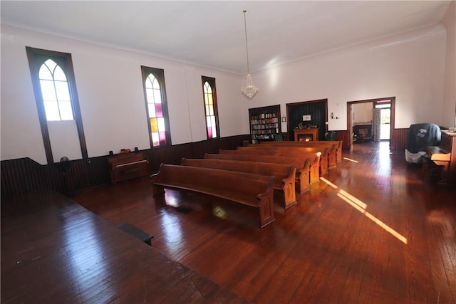 rec room with an inviting chandelier, dark hardwood / wood-style floors, and a healthy amount of sunlight