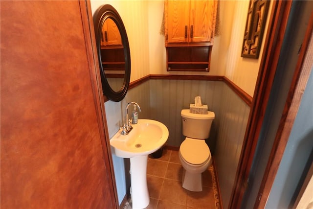 bathroom featuring sink, tile patterned floors, and toilet