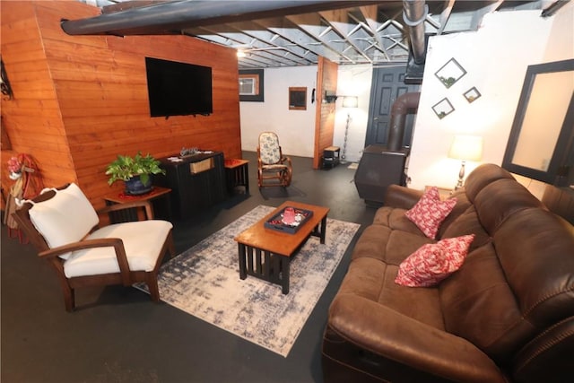 living room with concrete floors and wood walls