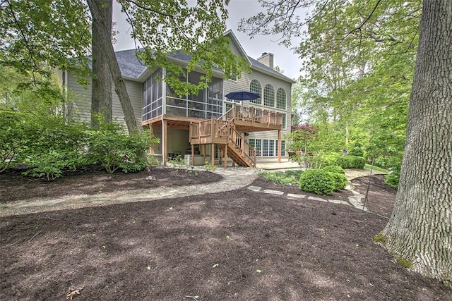 4140 S Lake Ct, Decatur, IL 62521 - back of property featuring a chimney, a patio, stairs, a sunroom, and a deck