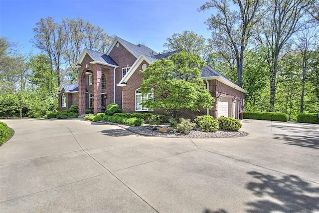 4140 S Lake Ct, Decatur, IL 62521 - traditional home featuring driveway, brick siding, and an attached garage