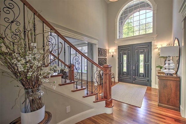 4140 S Lake Ct, Decatur, IL 62521 - foyer entrance featuring stairway, a high ceiling, baseboards, and wood finished floors
