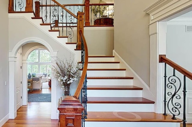 4140 S Lake Ct, Decatur, IL 62521 - stairs with arched walkways, a high ceiling, and wood finished floors