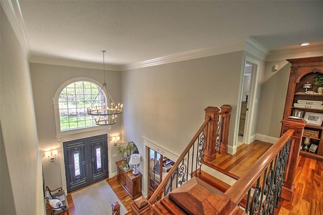 4140 S Lake Ct, Decatur, IL 62521 - foyer with wood finished floors, baseboards, ornamental molding, and a notable chandelier