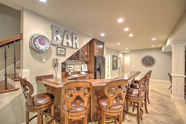4140 S Lake Ct, Decatur, IL 62521 - bar featuring a sink, decorative columns, stainless steel refrigerator with ice dispenser, recessed lighting, and a bar