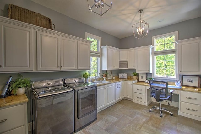 4140 S Lake Ct, Decatur, IL 62521 - laundry area with a notable chandelier, independent washer and dryer, plenty of natural light, a sink, and cabinet space