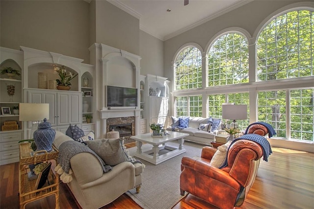 4140 S Lake Ct, Decatur, IL 62521 - living room featuring ornamental molding, wood finished floors, a towering ceiling, and a healthy amount of sunlight