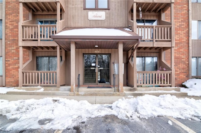 view of snow covered property entrance