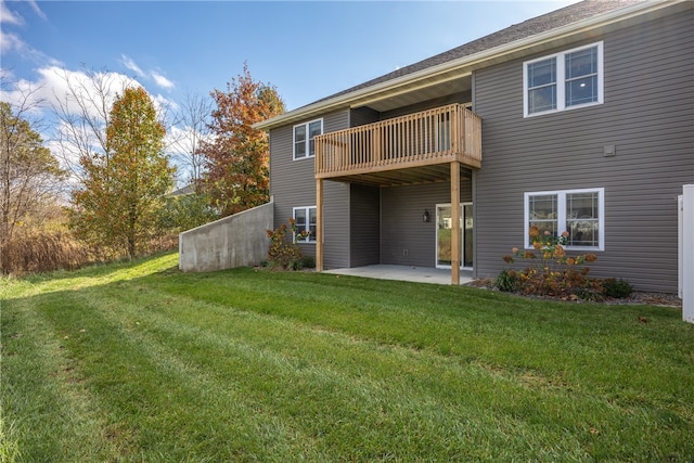 rear view of property with a yard and a patio