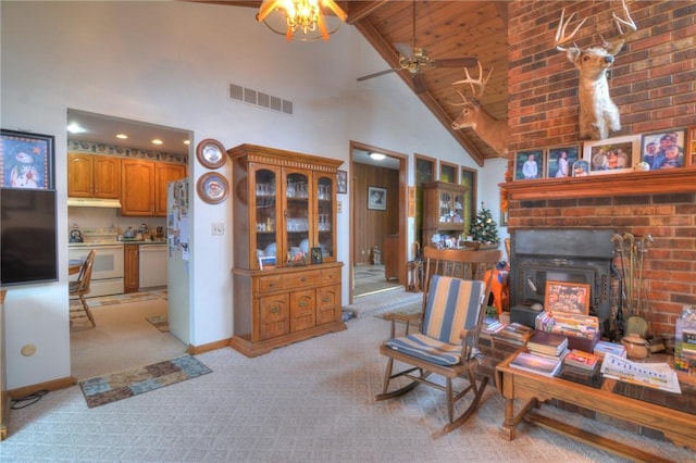 living area with light carpet, baseboards, visible vents, ceiling fan, and high vaulted ceiling