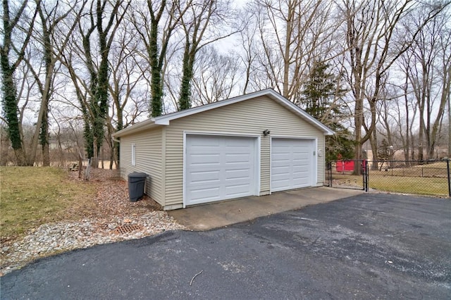 detached garage with fence and a gate